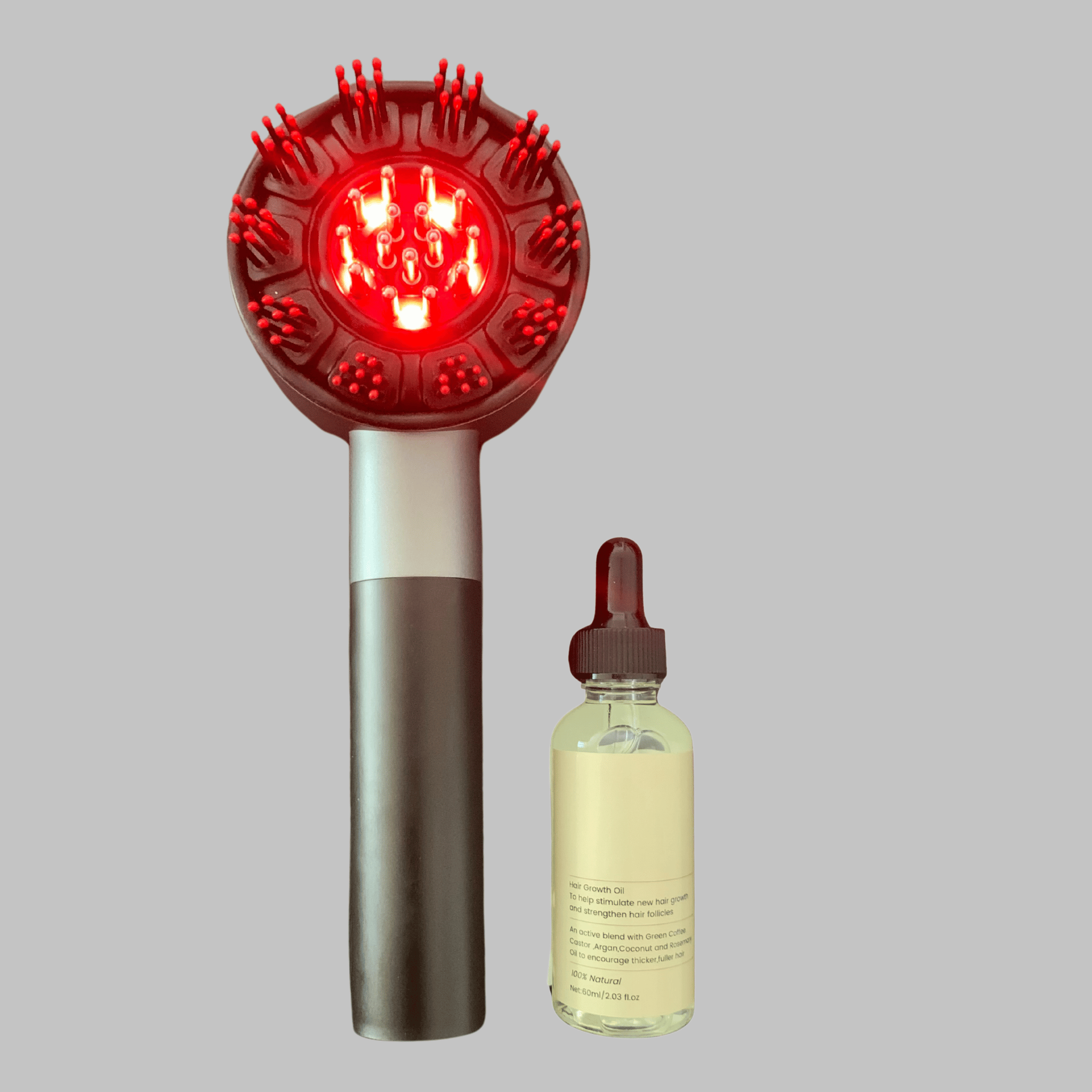 Red light therapy comb and natural hair growth oil on a gray background
